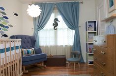 a baby's room is decorated in blue and white with seahorses on the wall