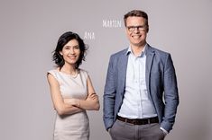 a man and woman standing next to each other in front of a gray wall with the words martha written on it