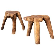 two wooden stools sitting next to each other