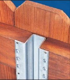 a close up of a wooden door with metal hinges on the bottom part