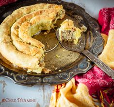 a pie on a plate with a spoon in it