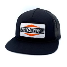 the harley davidson trucker hat is black and white with an orange patch on it