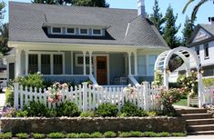 a white picket fence in front of a house