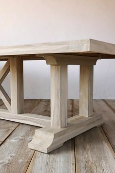 a wooden table sitting on top of a wooden floor