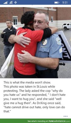 two police officers hugging each other in front of a building and the caption reads, this is what the media won't show