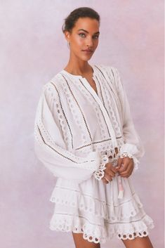 So in love with the Kava Top. Designed with a lightweight cotton fabric, this eyelet blouse is all about its delicate details. The top features long sleeves adorned with elastic cuffs and dainty ruffles, adding a touch of femininity and refinement to its silhouette. The sleeves are complemented by circle scallops while a hidden placket at the center front gives this piece a polished look while allowing for easy wear. With a flattering shoulder shape, this piece hits just below the waist, strikin Spring Tops With Lace Cuffs And Lantern Sleeves, Spring Lantern Sleeve Tops With Lace Cuffs, White Peasant Top With Smocked Cuffs And Long Sleeves, White Long Sleeve Peasant Top With Smocked Cuffs, White Blouse With Smocked Cuffs And Lantern Sleeves, Chic White Peasant Top With Lantern Sleeves, Summer Long Sleeve Tops With Cutwork Hem, White Long Sleeve Blouse With Smocked Cuffs, White Lantern Sleeve Blouse With Smocked Cuffs