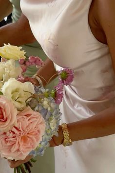 the bridesmaids are holding bouquets of flowers in their hands and wearing bracelets