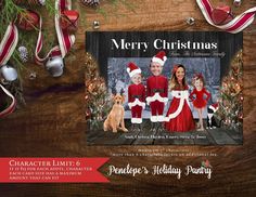 a christmas card with three people and a dog in red outfits on a wooden table