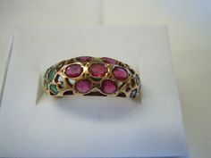 This ring contains 7 Rubies in a flower design in the center with 5 Emeralds on each side. The pierced work sets off the beauty of the ring. All stones are in good shape. The ring is in excellent condition. All stones are natural! The ring is a size 6. There are no markings on the ring. It tests 14K for sure or possibly higher. Thank you for viewing. Free Shipping USA Antique 14k Gold Ruby Ring With Multi-stone, Antique Oval Multi-stone Ring, Victorian Multi-stone Ruby Ring, Antique Yellow Gold Multi-stone Ruby Ring, Antique Multi-stone Round Emerald Ring, Antique Round Multi-stone Emerald Ring, Antique Multi-stone Ruby Ring In Yellow Gold, Traditional Oval Multi-stone Rings, Traditional Multi-stone Oval Rings