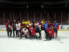 a group of people standing on top of an ice rink