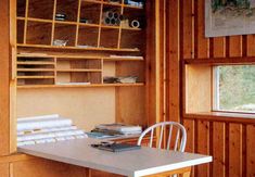 a table and chairs in a room with wood paneling