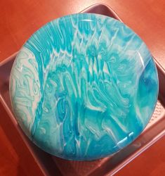 a blue and white plate sitting on top of a metal pan