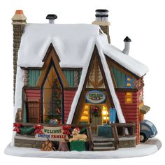 a christmas village with a red cabin and snow on the roof is shown in front of a white background