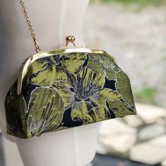 This green Lilly purse on a black background with gold metal clasps and gold color chain made in a cute shape great for many occasions including a casual night out, window shopping or a birthday :) ----------------------------------------------- Product name / Yellow Lily Color / As shown in the figure Fabric / Brocade Capacity / Day to day items (phone, wallet, keys, lipstick, makeup bag etc.) Function / hand held, crossbody Size / Clasp frame 22cm* Length24cm X height 17cm X width 7cm, ＋120cm Cheap Vintage Clutch For Party, Formal Green Bags With Fold Over Clasp, Green Evening Bag With Chain Strap, Elegant Rectangular Coin Purse With Fold Over Clasp, Chic Evening Bag With Gold-tone Hardware As Gift, Vintage Green Clutch For Everyday Use, Elegant Green Coin Purse, Vintage Green Formal Clutch, Elegant Green Coin Purse As Gift