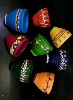 many different colored cups with designs on them