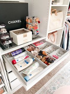 an open drawer in a closet filled with cosmetics and personal care items, including handbags