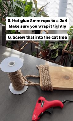 a spool of twine next to a pair of scissors on top of a table