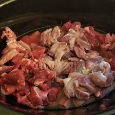 chopped meat in a slow cooker ready to be cooked