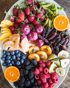 a white plate topped with lots of different types of fruits and vegtables