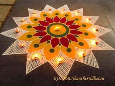 a decorated floor with lit candles in the shape of a flower