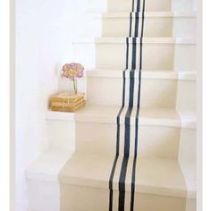 a white staircase with black and white stripes