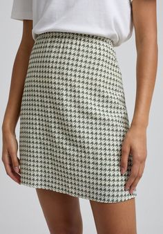 This season's latest iteration to our Sadie skirt is in our new Houndstooth print and cut from crepe. Fully lined, with an elasticated waist, it brings style, comfort, and versatility. Pair with flats and a cream jumper for daytime chic and switch for heels, a camisole and jacket to take you through the night. The perfect addition to your autumn wardrobe.  Cool machine wash only. Wash inside out and with similar colours 100% viscose Sourced in India  Cool machine wash only. Wash inside out and w Spring Workwear Skirt With Houndstooth Pattern, Houndstooth Mini Skirt For Spring, White Houndstooth Skirt For Fall, Spring Houndstooth Mini Skirt, Elegant Houndstooth Mini Skirt, White Mini Skirt With Houndstooth Pattern, Spring Mini Skirt With Houndstooth Pattern, Houndstooth Mini Skirt, Cream Jumper