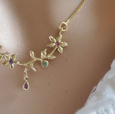 "This 14K gold flower necklace is a perfect love gift. This gold necklace and gemstone is a solid gold chain and pendant. That unique pendant is 3 small flowers and leaf and a tiny gold teardrop. Every small flower has a little gemstone in the center. The tiny teardrop has a marquise, Ruby. You can wear this unique gold necklace every day with every look. You can ask for different gemstones in the center of the flowers and in the little drop. Please let me know the length of the chain that you w Elegant Gold Birthstone Necklace With Flower Charm, Elegant Birthstone Necklace With Flower Pendant For Mom, Handmade Elegant Yellow Gold Birthstone Necklace, Elegant Handmade Birthstone Necklace For Anniversary, Unique Gold Necklace, Gold Necklace Unique, Gold Chain And Pendant, Gold Flower Necklace, Dainty Gemstone Necklace