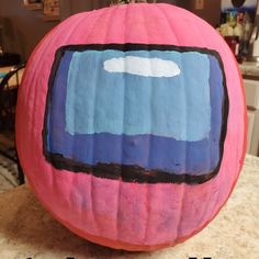 a painted pumpkin sitting on top of a counter