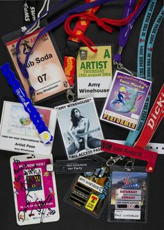 various lanyards and badges are laid out on a black surface, including one with a name tag