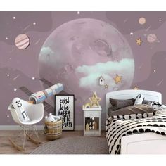 a room with a bed, chair and wallpaper that has an image of the moon on it