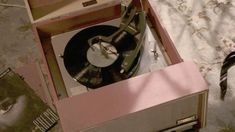 an old record player in a pink box