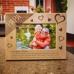 a wooden frame with an image of two people holding each other