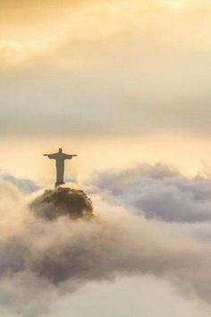 the statue is standing above the clouds on top of a hill in rio francisco, chile