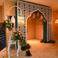 an elaborately decorated entrance to a room with lights and decorations on the walls, in front of a chalkboard sign