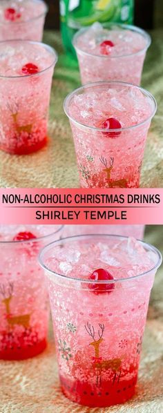 four cups filled with pink liquid and topped with christmas decorations