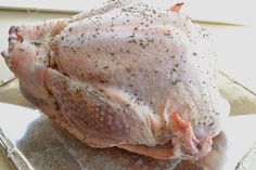 a raw chicken sitting on top of a glass plate