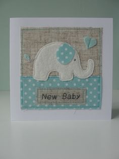 a card with an elephant on it and the words new baby written in white letters