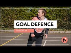 a woman standing in a parking lot with the words goal defence over her right shoulder