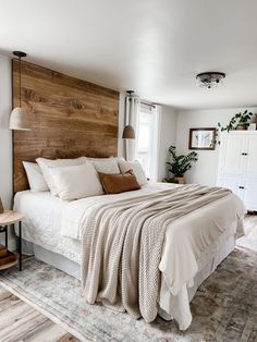 a bedroom with a large bed and wooden headboard