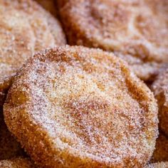 some sugared donuts are piled on top of each other