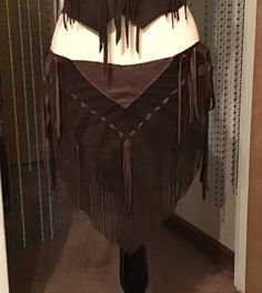 Top quality full grain deer leather and suede fringe skirt.  I put 2 ties on each side of skirt.  Fits a size 30 inch waist or hips up to 36 inch waist or hips. Anything over a 30 will have opening on both sides. Would look good with body suit or bathing suit bottoms. It is all handmade. Would look good with leather halter or bathing suit top. A little crop top tee shirt would look good too. This style is a really fun skirt to wear! I have one similar and love it! Thank you for visiting my shop! Fitted Fringe Skirt For Festival, Fringe Leather Skirt, Suede Fringe Skirt, Leather Halter, Womens Skirts, Bathing Suit Bottoms, Crop Top Tees, Hip Ups, Fringe Skirt