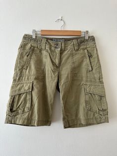 Vintage Y2K 'Fat Face' khaki green ripstop poplin cargo board shorts. Low waist.  UK 10/ small 12. Condition: In good condition. Some marks on front and back. Please see images.  Fabric: 100% cotton. Size: Size stated on garment 10. Fits a UK 10/ small 12. Please check measurements below for fit. Low waist: 32 inches. Hip: 38 inches. Height: 19 inches. Rise: 8.5 inches. Please note: All items are pre worn. Perfect or near perfect condition but some signs of wear may be apparent. Any major floors Cheap Green Cargo Shorts, Summer Knee-length Cargo Pants With Built-in Shorts, Outdoor Cargo Bermuda Shorts, Outdoor Cargo Pocket Bermuda Shorts, Utility Style Knee-length Bermuda Shorts For Summer, Utility Bermuda Knee-length Shorts For Summer, Summer Utility Bermuda Knee-length Shorts, Khaki Short Leg Cargo Shorts For Summer, Summer Khaki Short Length Cargo Pants