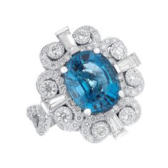 This is our new custom made Oval blue topaz with baguettes in 14K white gold.   This ring has small white round diamonds with total carat weight 1.50 and big white round diamonds with total carat weight 0.50. It has 0.50 carat 4 taper baguette on the 4 corners of the ring and the center stone is a 5 carat nice cushion blue topaz. This ring is also available in custom sizes and alternative center stones. Metal: 14KW Center Stone: Cushion Blue Topaz Center Stone Weight: 5 ct Side Stones: Taper Bag Blue Diamond Ring With Baguette Diamonds, Luxury Baguette-cut Topaz Ring, Elegant Blue Diamond Ring With Baguette Diamonds, Ring With Baguettes, Blue Topaz Ring, Baguette Diamond, Topaz Ring, Rings Statement, The 4