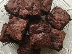 chocolate brownies on a glass plate sitting on a table