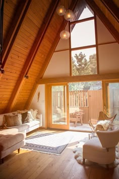 a living room filled with furniture and lots of windows