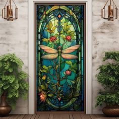 an ornate stained glass door with flowers and dragonflys