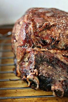 a large piece of meat sitting on top of a metal rack