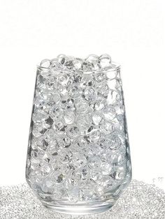 a glass filled with lots of bubbles on top of a table