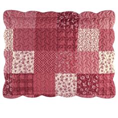 a red and white patchwork pillow on a white background