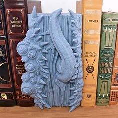 there is a bookend made out of books on the shelf